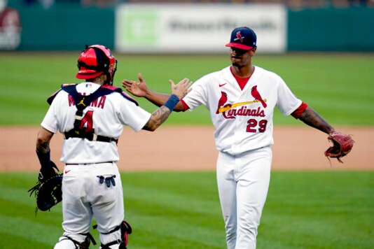 St. Louis Cardinals relief pitcher Alex Reyes (29) and catcher Yadier Molina (4) celebrate after defeating the Milwaukee Brewers in a baseball game to earn a playoff birth Sunday, Sept. 27, 2020, in St. Louis. (AP Photo/Jeff Roberson)