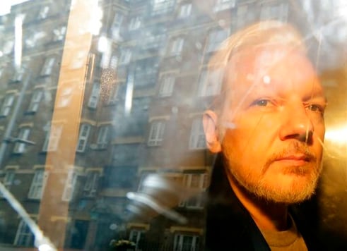 FILE - In this Wednesday May 1, 2019 file photo buildings are reflected in the window as WikiLeaks founder Julian Assange is taken from court, where he appeared on charges of jumping British bail seven years ago, in London. A lawyer for Julian Assange said Friday, Sept. 25, 2020 that the WikiLeaks founders situation will be worse if President Donald Trump is re-elected in November than if Democrat rival Joe Biden wins.
Edward Fitzgerald said at Assanges extradition hearing in London that Assange will suffer if he is sent to the U.S. to face spying charges regardless of who wins the Nov. 3 election. (AP Photo/Matt Dunham, File)
