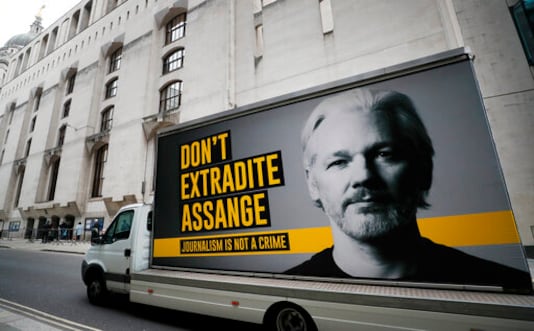A lorry with a billboard of Julian Assange arrives at the Old Bailey court in London, Monday, Sept. 21, 2020 as the Julian Assange extradition hearing to the US continues. (AP Photo/Frank Augstein)
