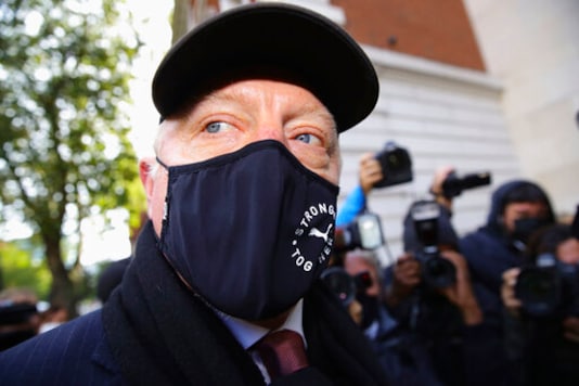 Retired German tennis player Boris Becker, foreground, arrives at Westminster Magistrates Court in London, after being declared bankrupt and accused of not complying with obligations to disclose information, Thursday, Sept. 24, 2020. Becker is being prosecuted by the Insolvency Service. (Aaron Chown/PA via AP)