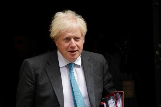 British Prime Minister Boris Johnson leaves 10 Downing Street in London, to attend the weekly Prime Minister's Questions at the Houses of Parliament, in London, Wednesday, Sept. 16, 2020. (AP Photo/Matt Dunham)
