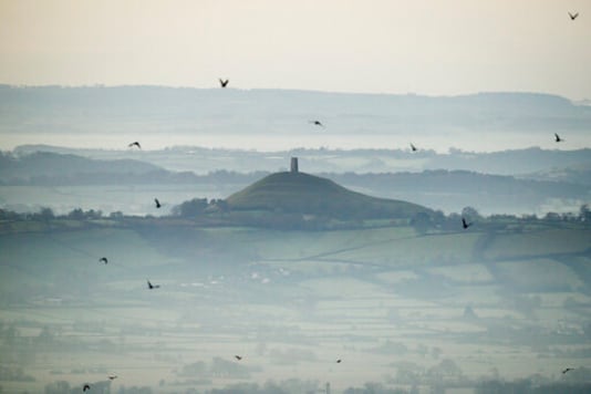 FILE - This Dec. 19, 2017 file photo shows Glastonbury Tor in Glastonbury, England, which is cared for by the National Trust. Britains National Trust which looks after hundreds of the countrys well-loved historic sites, published a report Tuesday Sept. 22, 2020, said 93 of its sites have connections with aspects of the global slave trade or Britains colonial history. Glastonbury Tor is shown to have links to successful compensation claims as a result of the abolition of slavery,. (Ben Birchall/PA via AP, File)