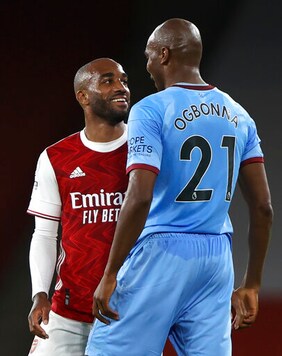 West Ham's Angelo Ogbonna and Arsenal's Alexandre Lacazette confront each other during the English Premier League soccer match between Arsenal and West Ham at the Emirates Stadium in London, England, Saturday, Sept. 19, 2020. (AP Photo/Ian Walton, Pool)