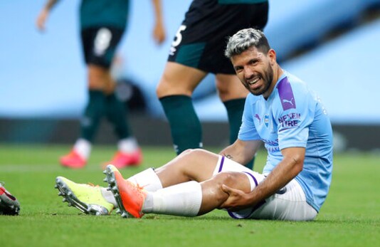 Manchester City's Sergio Aguero reacts as he sits on the pitch injured during the English Premier League soccer match between Manchester City and Burnley at Etihad Stadium, in Manchester, England, Monday, June 22, 2020. (AP Photo/Martin Rickett,Pool)