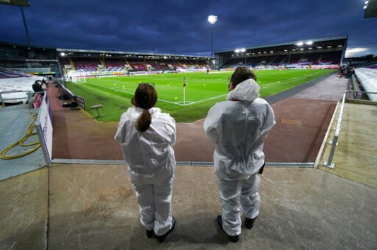 Medical staff stand on the field ahead of the English Premier League soccer match between Burnley and Southampton at Turf Moor in Burnley, England, Saturday, Sept. 26, 2020. (Jon Super/Pool via AP) Medical staff stand on the field ahead of the English Premier League soccer match between Burnley and Southampton at Turf Moor in Burnley, England, Saturday, Sept. 26, 2020. (Jon Super/Pool via AP)