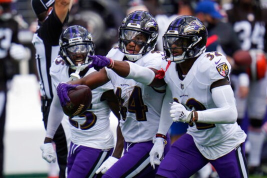 Baltimore Ravens cornerback Marlon Humphrey (44) celebrates after intercepting a pass, during an NFL football game against the Cleveland Browns, Sunday, Sept. 13, 2020, in Baltimore. To the right Baltimore Ravens safety DeShon Elliott (32) and cornerback Tavon Young (25), left. (AP Photo/Julio Cortez)