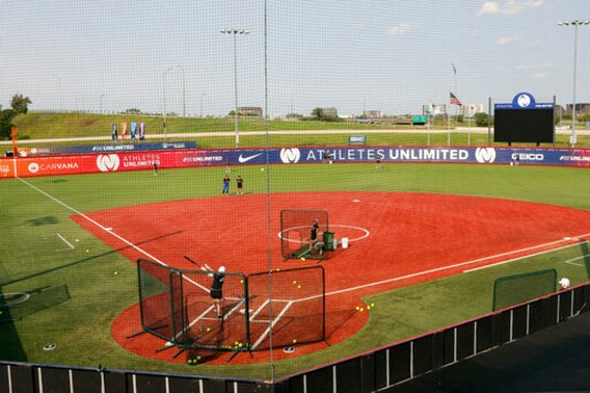 Players for Athletes Unlimited practice on Wednesday, Sept. 16, 2020, in Rosemont, Ill. Elite players are living life in a bubble to prevent the spread of COVID during the inaugural Athletes Unlimited softball season. When they're not at the ballpark or an indoor facility across the parking lot, they are at their hotel or apartment. Everywhere else is off limits to them. (AP Photo/Teresa Crawford)