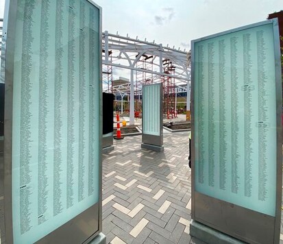 This photo provided by MKSK shows some of the 11 pylons that list every player who played a down in an NFL regular or postseason game, in Centennial Plaza under construction in downtown Canton, Ohio. Centennial Plaza, developed with the help of $12 million in funding from the citizens and businesses of Canton, will occupy a two-acre city block formerly known as Market Square. (Courtesy of MKSK/Pro Football Hall of Fame via AP)
