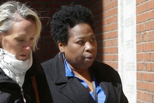 FILE - In this March 25, 2019, file photo, Niki Williams, right, a college entrance exam administrator, arrives at federal court in Boston to face charges in a nationwide college admissions bribery scandal. Williams is scheduled to plead guilty to charges on Friday, Sept. 25, 2020. (AP Photo/Steven Senne, File)