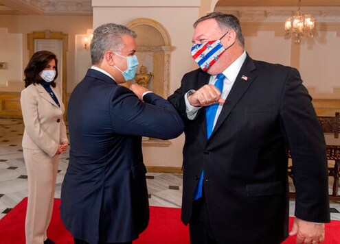 In this handout photo released by Colombia's Presidential Press Office, Colombian President Ivan Duque and U.S. Secretary of State Mike Pompeo bump elbows before their meeting at the presidential house in Bogota, Colombia, Saturday, Sept. 19, 2020. Pompeo on Saturday wrapped up a tour of four South American countries  three of them neighbors of Venezuela, whose socialist government is under intense U.S. pressure. (Nicolas Galeano/Colombia's Presidential Press Office via AP)