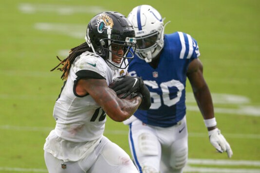 Jacksonville Jaguars wide receiver Laviska Shenault Jr., left, scores a touchdown on a 16-yard pass play in front of Indianapolis Colts defensive end Justin Houston during the first half of an NFL football game, Sunday, Sept. 13, 2020, in Jacksonville, Fla. (AP Photo/Stephen B. Morton)