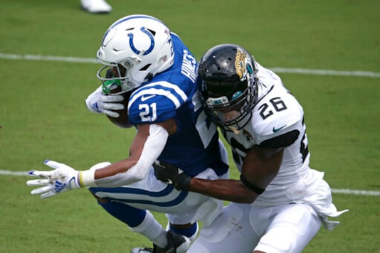 Indianapolis Colts running back Nyheim Hines (21) scores a touchdown on a 12-yard run as he is brought down by Jacksonville Jaguars safety Jarrod Wilson (26) during the first half of an NFL football game, Sunday, Sept. 13, 2020, in Jacksonville, Fla. (AP Photo/Stephen B. Morton)
