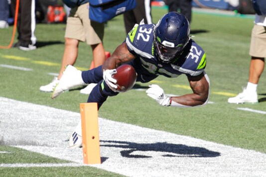 Seattle Seahawks running back Chris Carson (32) dives near the end zone during the first half of an NFL football game against the Dallas Cowboys, Sunday, Sept. 27, 2020, in Seattle. The Seahawks won 38-31. (AP Photo/John Froschauer) Seattle Seahawks running back Chris Carson (32) dives near the end zone during the first half of an NFL football game against the Dallas Cowboys, Sunday, Sept. 27, 2020, in Seattle. The Seahawks won 38-31. (AP Photo/John Froschauer)