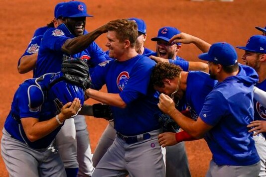 Chicago Cubs starting pitcher Alec Mills is swarmed by teammates after throwing a no hitter at a baseball game against the Milwaukee Brewers Sunday, Sept. 13, 2020, in Milwaukee. The Cubs won 12-0. (AP Photo/Morry Gash)
