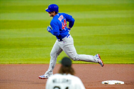 Chicago Cubs' Anthony Rizzo (44) rounds second after hitting a solo home run off Pittsburgh Pirates starting pitcher Trevor Williams, bottom, during the first inning of a baseball game in Pittsburgh, Wednesday, Sept. 23, 2020. (AP Photo/Gene J. Puskar)
