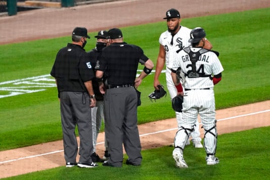 Chicago White Sox manager Rick Renteria, second from left, argues with umpires as catcher Yasmani Grandal, right, and relief pitcher Jimmy Cordero react during the seventh inning of a baseball game against the Chicago Cubs in Chicago, Friday, Sept. 25, 2020. Cordero ejected by home plate umpire Dan Bellino. (AP Photo/Nam Y. Huh) Chicago White Sox manager Rick Renteria, second from left, argues with umpires as catcher Yasmani Grandal, right, and relief pitcher Jimmy Cordero react during the seventh inning of a baseball game against the Chicago Cubs in Chicago, Friday, Sept. 25, 2020. Cordero ejected by home plate umpire Dan Bellino. (AP Photo/Nam Y. Huh)