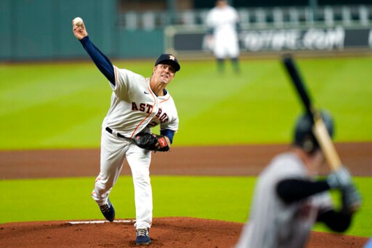 Houston Astros starting pitcher Zack Greinke, left, throws to Arizona Diamondbacks' Christian Walker during the first inning of a baseball game Friday, Sept. 18, 2020, in Houston. (AP Photo/David J. Phillip)