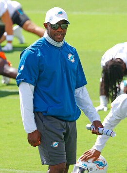 Miami Dolphins head coach Brian Flores looks on as the players stretch during NFL football practice in Davie, Fla., Friday, Sept. 11, 2020. (AP Photo/Joel Auerbach)