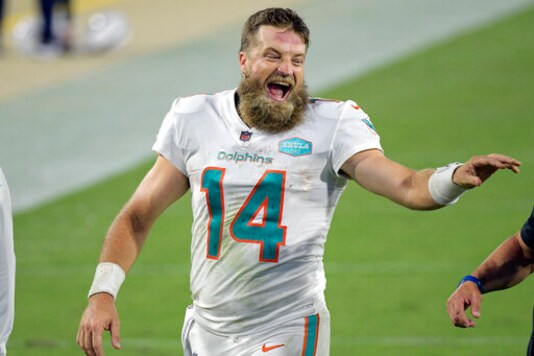 Miami Dolphins quarterback Ryan Fitzpatrick laughs with coaches as he comes off the field after defeating the Jacksonville Jaguars in an NFL football game, Thursday, Sept. 24, 2020, in Jacksonville, Fla. (AP Photo/Phelan M. Ebenhack) Miami Dolphins quarterback Ryan Fitzpatrick laughs with coaches as he comes off the field after defeating the Jacksonville Jaguars in an NFL football game, Thursday, Sept. 24, 2020, in Jacksonville, Fla. (AP Photo/Phelan M. Ebenhack)