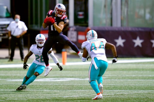 New England Patriots wide receiver Julian Edelman (11) attempts to catch a pass between Miami Dolphins safety Bobby McCain (28) and linebacker Elandon Roberts (44) in the first half of an NFL football game, Sunday, Sept. 13, 2020, in Foxborough, Mass. (AP Photo/Charles Krupa) New England Patriots wide receiver Julian Edelman (11) attempts to catch a pass between Miami Dolphins safety Bobby McCain (28) and linebacker Elandon Roberts (44) in the first half of an NFL football game, Sunday, Sept. 13, 2020, in Foxborough, Mass. (AP Photo/Charles Krupa)