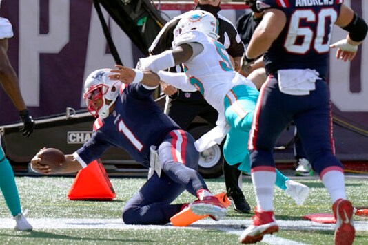 New England Patriots quarterback Cam Newton (1) scores his second rushing touchdown as Miami Dolphins linebacker Jerome Baker (55) chases in the second half of an NFL football game, Sunday, Sept. 13, 2020, in Foxborough, Mass. (AP Photo/Steven Senne)