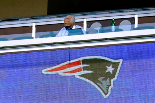 New England Patriots owner Robert Kraft wears a mask as he sits alone in his box in the first half of an NFL football game against the Miami Dolphins during the coronavirus pandemic, Sunday, Sept. 13, 2020, in Foxborough, Mass. (AP Photo/Charles Krupa)
