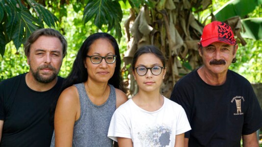 A group who have been stranded in Tahiti, pictured from left, Benjamin Baude, Kissy Ika Chavez Baude, Gaa Baude Ika and Thierry Gourtay in Afareaitu on Moorea Island, Tahiti, Saturday, Sept. 19, 2020. A group of 25 residents from remote Easter Island has been stranded far from home for six months now. Many arrived in March planning to stay for just a few weeks. But they got stuck when the virus swept across the globe and their flights back home on LATAM airlines were canceled. LATAM says it doesn't know when it will restart the route.(Teraihau Rio via AP)