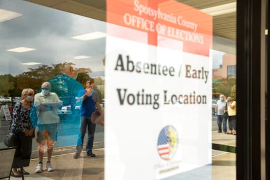 Voters wait in line to cast ballots in the general election, Friday, Sept. 18, 2020, at the Office of Elections satellite location in Spotsylvania, Va., on the first day of the state's 45-day early voting period. (Mike Morones/The Free Lance-Star via AP) Voters wait in line to cast ballots in the general election, Friday, Sept. 18, 2020, at the Office of Elections satellite location in Spotsylvania, Va., on the first day of the state's 45-day early voting period. (Mike Morones/The Free Lance-Star via AP)