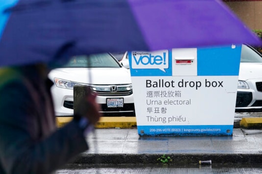 A pedestrian walks past a King County ballot drop box, closed until ballots are mailed about three weeks before the election, on a Seattle street Thursday, Sept. 24, 2020. (AP Photo/Elaine Thompson) A pedestrian walks past a King County ballot drop box, closed until ballots are mailed about three weeks before the election, on a Seattle street Thursday, Sept. 24, 2020. (AP Photo/Elaine Thompson)