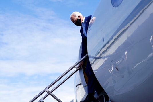 FILE - In this Sept. 23, 2020, file photo Democratic presidential candidate former Vice President Joe Biden arrives at Charlotte Douglas International Airport in Charlotte, N.C. The final stretch of a presidential campaign is typically a nonstop mix of travel, caffeine and adrenaline. But as the worst pandemic in a century bears down on the United States, Joe Biden is taking a lower key approach. (AP Photo/Carolyn Kaster, File)