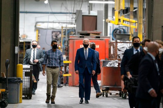 Democratic presidential candidate former Vice President Joe Biden tours the Wisconsin Aluminum Foundry with Sachin Shivaram, CEO of Wisconsin Aluminum Foundry, in Manitowoc, Wis., Monday, Sept. 21, 2020. (AP Photo/Carolyn Kaster)