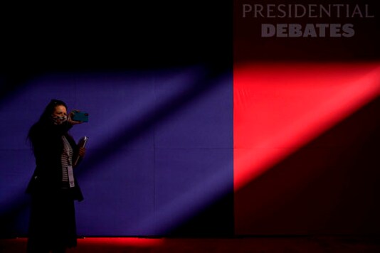 A member of the production team uses a cell phone to make images of the hall ahead of the first presidential debate between Republican candidate President Donald Trump and Democratic candidate former Vice President Joe Biden at the Health Education Campus of Case Western Reserve University, Tuesday, Sept. 29, 2020, in Cleveland. (AP Photo/Julio Cortez) A member of the production team uses a cell phone to make images of the hall ahead of the first presidential debate between Republican candidate President Donald Trump and Democratic candidate former Vice President Joe Biden at the Health Education Campus of Case Western Reserve University, Tuesday, Sept. 29, 2020, in Cleveland. (AP Photo/Julio Cortez)