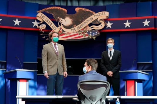 Mock debaters stand onstage as preparations take place for the first Presidential debate in the Sheila and Eric Samson Pavilion, Monday, Sept. 28, 2020, in Cleveland. The first debate between President Donald Trump and Democratic presidential candidate, former Vice President Joe Biden is scheduled to take place Tuesday, Sept. 29. (AP Photo/Patrick Semansky)