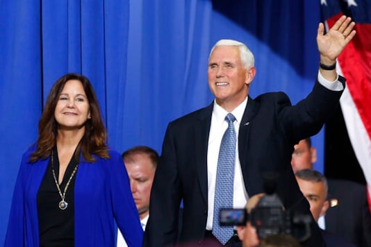 FILE - In this Oct. 10, 2019 file photo, Vice President Mike Pence and his wife Karen arrive prior to a campaign rally speech by appear in Minneapolis. Vice President Pence is bringing President Donald Trump's law-and-order campaign message to Minneapolis on Thursday, Sept. 24, 2020, showing support for law enforcement in the city where George Floyd's death after police tried to arrest him sparked angry and sometimes violent protests that spread around the world. (AP Photo/Jim Mone, File)