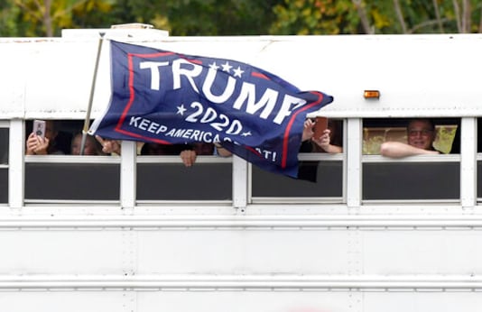 Supporters of President Donald Trump arrive by bus for a Trump campaign rally at Harrisburg International Airport, Saturday, Sept. 26, 2020, in Middletown, Pa. (AP Photo/Steve Ruark)