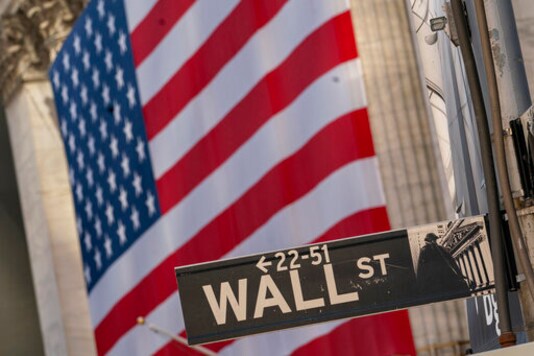 The Wall Street street sign is framed by a giant American flag hanging on the New York Stock Exchange, in a Monday, Sept. 21, 2020 file photo. Stocks are opening higher on Wall Street, recovering after their first four-week losing streak in more than a year. A burst of corporate deals helped give investors confidence to put money back in the market, and the S&P 500 rose 1.4% in the early going Monday, Sept. 28, 2020. (AP Photo/Mary Altaffer, File) The Wall Street street sign is framed by a giant American flag hanging on the New York Stock Exchange, in a Monday, Sept. 21, 2020 file photo. Stocks are opening higher on Wall Street, recovering after their first four-week losing streak in more than a year. A burst of corporate deals helped give investors confidence to put money back in the market, and the S&P 500 rose 1.4% in the early going Monday, Sept. 28, 2020. (AP Photo/Mary Altaffer, File)