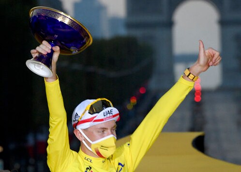 Tour de France winner Slovenia's Tadej Pogacar celebrates his victory on the podium Sunday Sept. 20, 2020 in Paris. In a stunning performance for the ages, Tour de France rookie Tadej Pogacar won cycling's showpiece race Sunday on the eve of his 22nd birthday. (Stephane Mantey, Pool via AP)