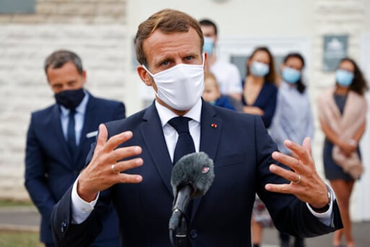 French President Emmanuel Macron speaks after visiting a Mother and Child Protection Centre (PMI) in Longjumeau, a southern suburb of Paris, Wednesday, Sept. 23, 2020. French President wants to expand paternity leave to one month  and require fathers to take time off with their newborns. President Emmanuel Macron earlier announced the plan on Instagram before visiting the child-care facility. (Ludovic Marin/POOL via AP)