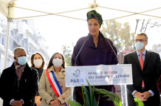 French actress Marie-Noelle Eusebe delivers her speech during the inauguration of a park honoring  'Solitude', a woman who fought for the liberation of slaves on the Caribbean island of Guadeloupe, in Paris, Saturday Sept. 26, 2020. Paris Mayor Anne Hidalgo, second left, plans to erect a statue in honour of Solitude at the site, the city's first statue honoring a Black woman. Amid global protests against monuments to white men linked to colonialism or the slave trade, French leaders have pushed instead to erect new monuments to more diverse, lesser-known historical figures. (AP Photo/Lewis Joly)