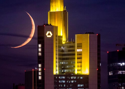 The crescent moon sets behind the Commerzbank building in Frankfurt, Germany, late Saturday, Sept. 19, 2020. (AP Photo/Michael Probst)