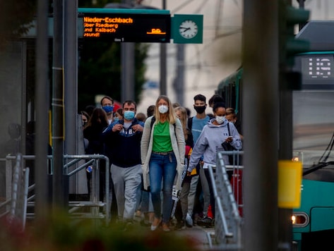 People wear face masks as they walk away from a subway station in Frankfurt, Germany, Thursday, Sept. 24, 2020. (AP Photo/Michael Probst) People wear face masks as they walk away from a subway station in Frankfurt, Germany, Thursday, Sept. 24, 2020. (AP Photo/Michael Probst)