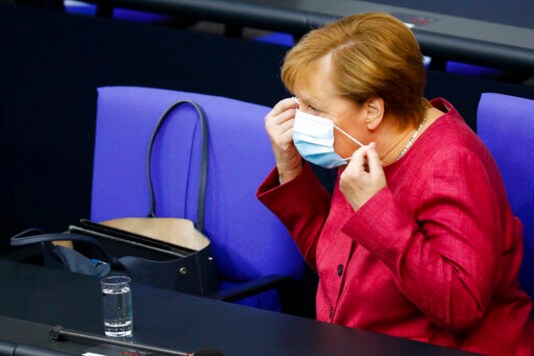 German Chancellor Angela Merkel arrives for a debate about her policy as part of Germany's budget 2021 debate at the parliament Bundestag in Berlin, Germany, Wednesday, Sept. 30, 2020. (AP Photo/Markus Schreiber)