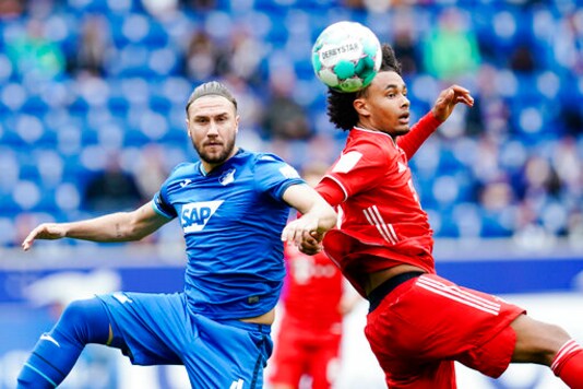 Hoffenheim's Ermin Bicakcic, left, and Munich's Joshua Zirkzee challenge for the ball during the German Bundesliga soccer match between TSG 1899 Hoffenheim and Bayern Munich in Sinsheim, Germany, Sunday, Sept. 27, 2020. (Uwe Anspach/dpa via AP) Hoffenheim's Ermin Bicakcic, left, and Munich's Joshua Zirkzee challenge for the ball during the German Bundesliga soccer match between TSG 1899 Hoffenheim and Bayern Munich in Sinsheim, Germany, Sunday, Sept. 27, 2020. (Uwe Anspach/dpa via AP)