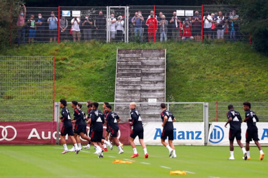 People watch the first official training session of FC Bayern Munich soccer club in Munich, Germany, Friday, Sept. 11, 2020. The German Bundesliga starts next Friday, Sept. 18, 2020. (AP Photo/Matthias Schrader) People watch the first official training session of FC Bayern Munich soccer club in Munich, Germany, Friday, Sept. 11, 2020. The German Bundesliga starts next Friday, Sept. 18, 2020. (AP Photo/Matthias Schrader)
