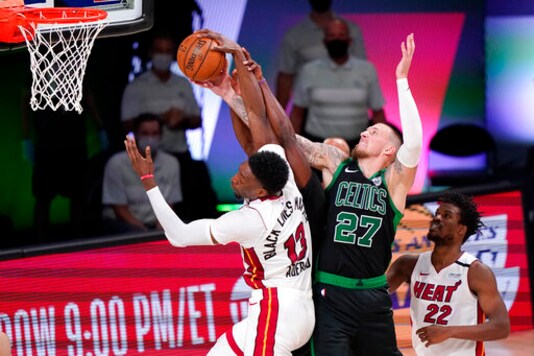 Miami Heat's Bam Adebayo (13) and Boston Celtics' Daniel Theis (27) battle for the ball during the second half of an NBA conference final playoff basketball game Friday, Sept. 25, 2020, in Lake Buena Vista, Fla. (AP Photo/Mark J. Terrill)