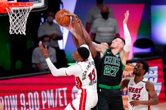 Miami Heat's Bam Adebayo (13) and Boston Celtics' Daniel Theis (27) battle for the ball during the second half of an NBA conference final playoff basketball game Friday, Sept. 25, 2020, in Lake Buena Vista, Fla. (AP Photo/Mark J. Terrill) Miami Heat's Bam Adebayo (13) and Boston Celtics' Daniel Theis (27) battle for the ball during the second half of an NBA conference final playoff basketball game Friday, Sept. 25, 2020, in Lake Buena Vista, Fla. (AP Photo/Mark J. Terrill)