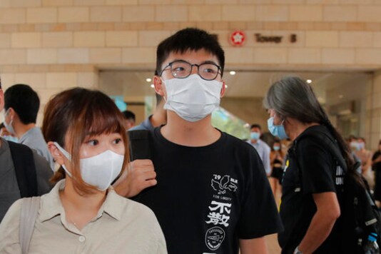 Various of groups of pro-democracy activists including Joshua Wong, center, arrive at a court in Hong Kong, Tuesday, Sept. 15, 2020. Prominent activists Jimmy Lai and Joshua Wong were among more than two dozen activists appearing in court after being charged of participating in unlawful assembly. They were charged for joining a vigil last June 4 to commemorate the anniversary of the 1989 Tiananmen crackdown. While the event has been held every year, authorities did not grant permission for the gathering this year citing concerns over the spread of coronavirus. (AP Photo/Kin Cheung)