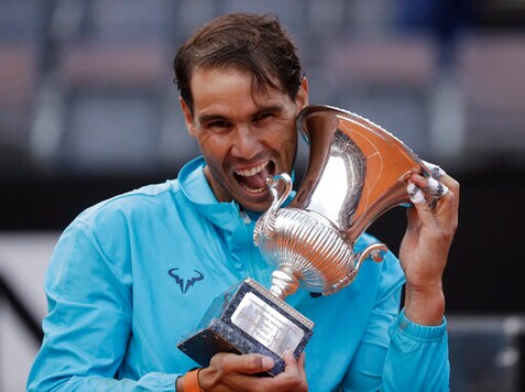 FILE - In this May 19, 2019 file photo, Rafael Nadal of Spain holds his trophy after winning against Novak Djokovic of Serbia at the end of their final match at the Italian Open tennis tournament, in Rome. Rafael Nadal is preparing his return to tennis after a seven-month layoff at next weeks Italian Open. The Foro Italico is always a special place for me and even more so this year as it will be my first tournament following a long period without playing, Nadal, who has won the Rome tournament a record nine times, said in a video message played at the events presentation Tuesday, Sept. 8, 2020. (AP Photo/Gregorio Borgia)