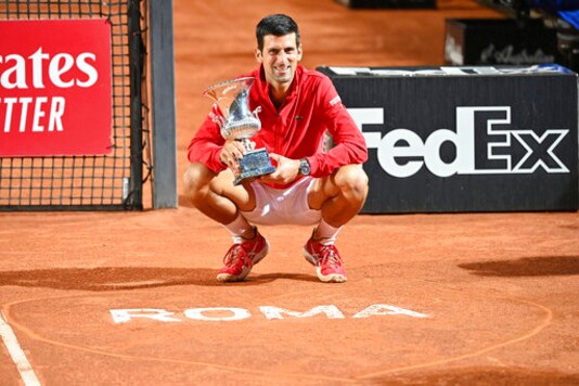 Serbia's Novak jokovi poses with his trophy after winning winning his match with Argentina's Diego Sebastin Schwartzman during their final match at the Italian Open tennis tournament, in Rome, Monday, Sept. 21, 2020. (Alfredo Falcone/LaPresse via AP)