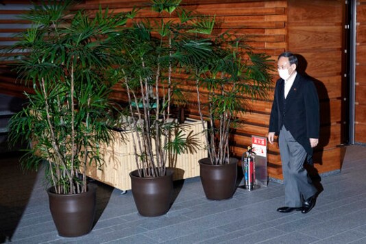 Japan's Prime Minister-elect Yoshihide Suga leaves his official residence for the Imperial Palace to attend the attestation ceremony of his new Cabinet, Wednesday, Sept. 16, 2020, in Tokyo. (AP Photo/Eugene Hoshiko)